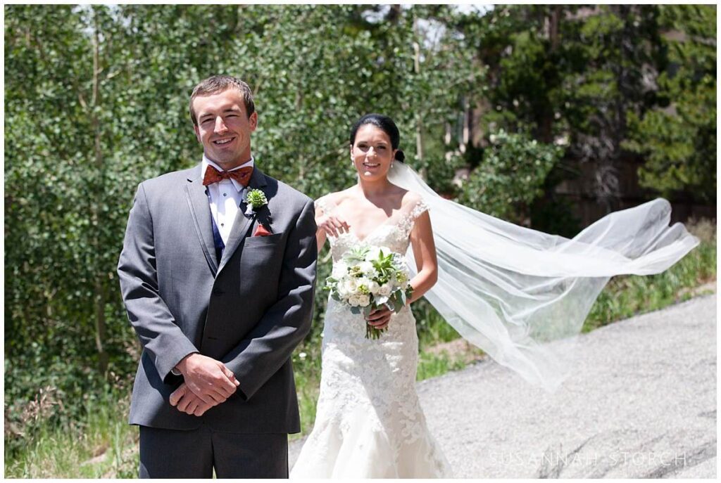 a bride approaches her groom from behind for the first look on her mountain wedding day