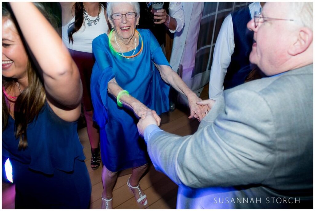 an older woman dances and has fun during a wedding reception