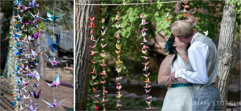 Planet Bluegrass wedding Paper cranes decorate a wedding at Planet Bluegrass in Lyons, Colorado. And the bride and groom kiss.